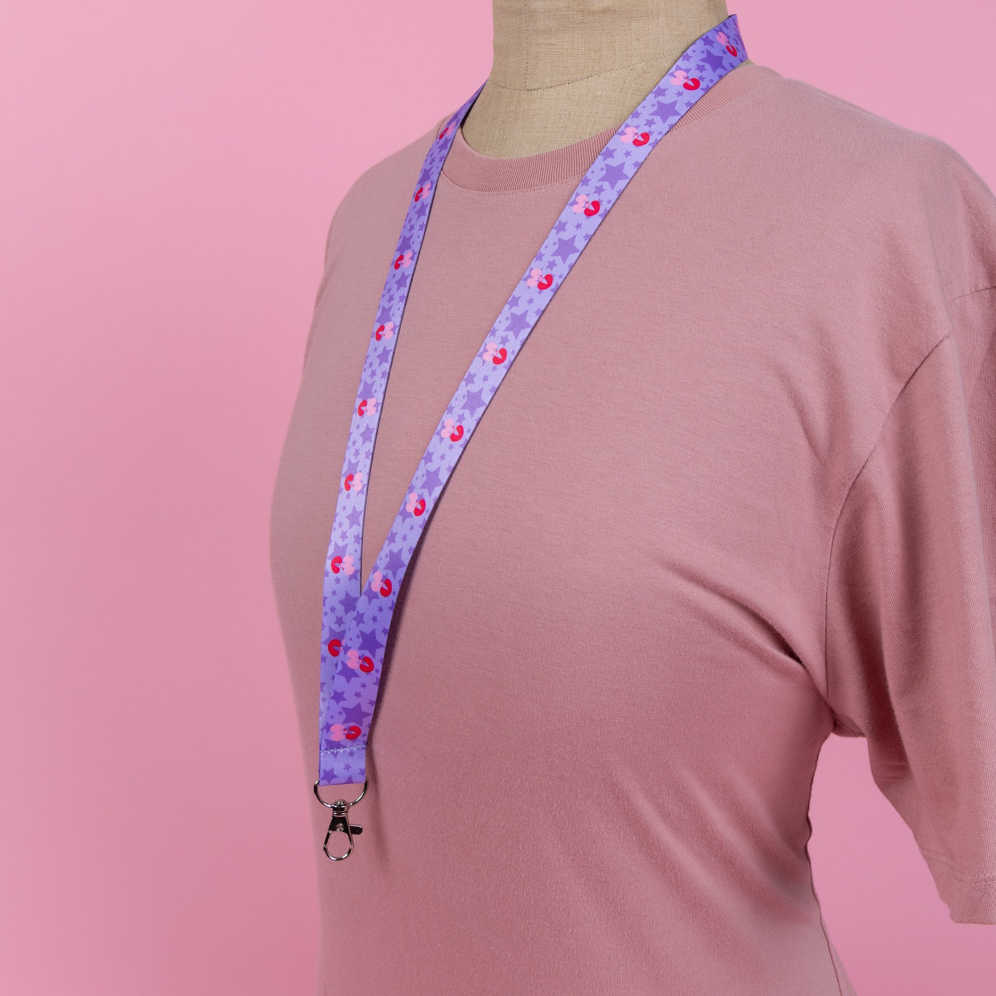 Photograph of Cute Mars N' Venus (MnV) starry logo lanyard; displayed around a neck/worn by a mannequin.