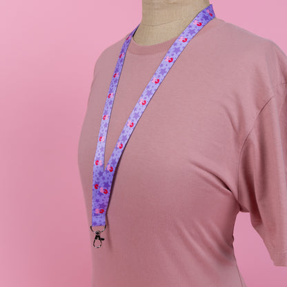 Photograph of Cute Mars N' Venus (MnV) starry logo lanyard; displayed around a neck/worn by a mannequin.