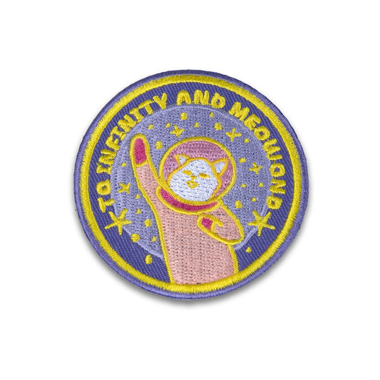 Photograph of Cute Cat Astronaut (Catstronaut) iron-on patch, surrounded by stars, reads the phrase 'To Infinity And Meowond'.