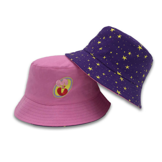 Photograph of Cute Mars N' Venus (MnV) reversible bucket hat; one side is pink with an embroidered Mars N' Venus (MnV) logo, and the other features a cute starry pattern screenprinted onto a purple cotton.