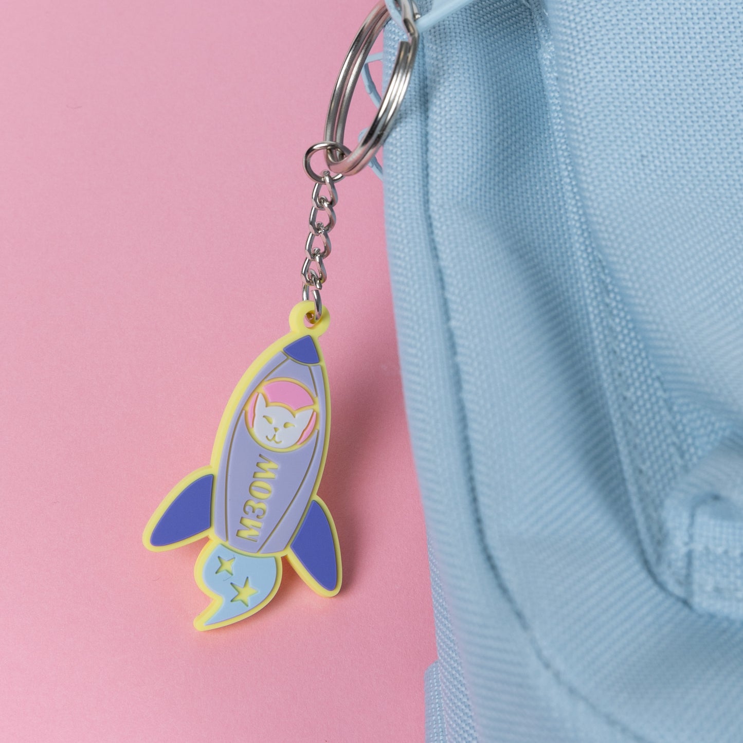 Photograph of Cute Cat Astronaut (Catstronaut) PVC keychain, in her space rocket, The M3OW; attached to a rucksack.