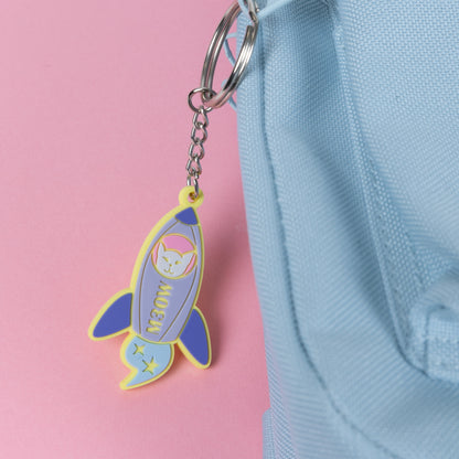 Photograph of Cute Cat Astronaut (Catstronaut) PVC keychain, in her space rocket, The M3OW; attached to a rucksack.
